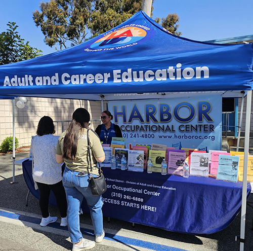 April 10, 2025 - job seekers speak to staff at the Harbor Occupational table during the Harbor Region Connect LA Job Fair